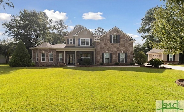 view of front of house with brick siding, concrete driveway, and a front yard