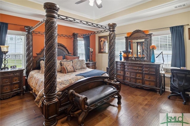 bedroom with ceiling fan, visible vents, dark wood-style flooring, and ornamental molding