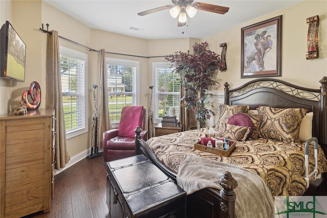 bedroom with ceiling fan, visible vents, baseboards, and dark wood finished floors