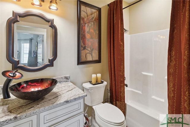 full bathroom with washtub / shower combination, vanity, and toilet