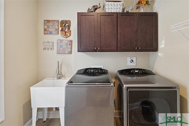 washroom featuring cabinet space, independent washer and dryer, and baseboards