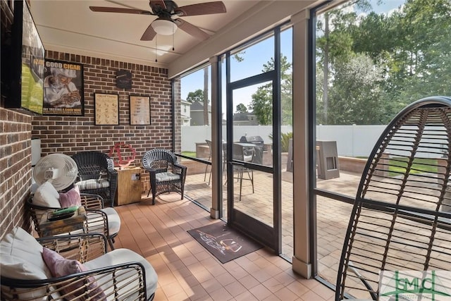 sunroom / solarium featuring ceiling fan