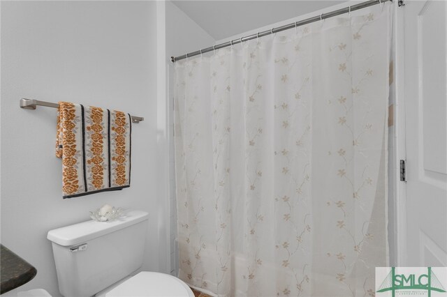 bathroom with a shower with curtain and toilet