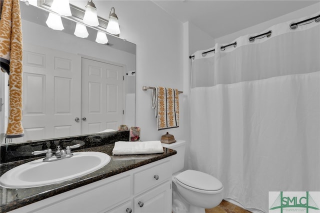 bathroom with vanity, toilet, and a shower with shower curtain