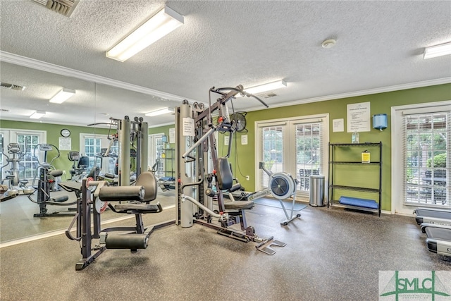 exercise room with ornamental molding and a textured ceiling