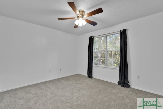 carpeted spare room with a textured ceiling and ceiling fan