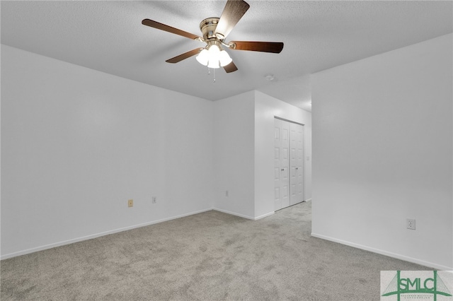 carpeted empty room with a textured ceiling and ceiling fan