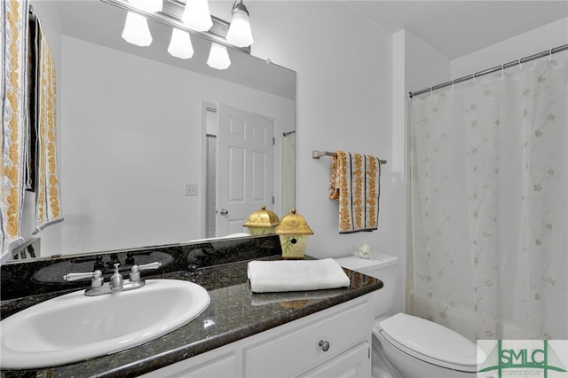 bathroom featuring walk in shower, toilet, and vanity