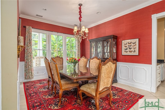 dining space featuring crown molding, an inviting chandelier, and light tile patterned floors