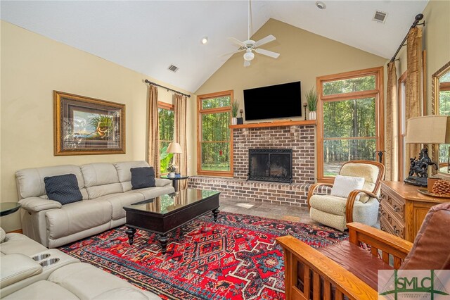 living room with high vaulted ceiling, ceiling fan, and a brick fireplace