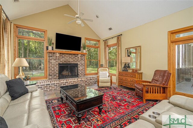 living room with high vaulted ceiling, ceiling fan, and a brick fireplace