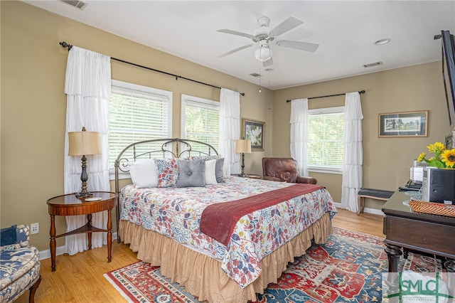 bedroom with ceiling fan and light hardwood / wood-style floors