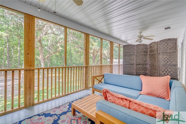 sunroom with a wealth of natural light and ceiling fan