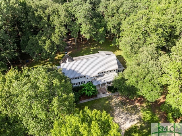 drone / aerial view with a wooded view