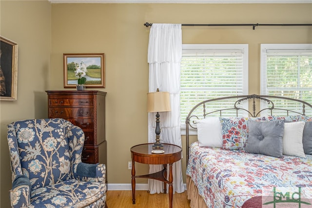 bedroom with wood finished floors and baseboards