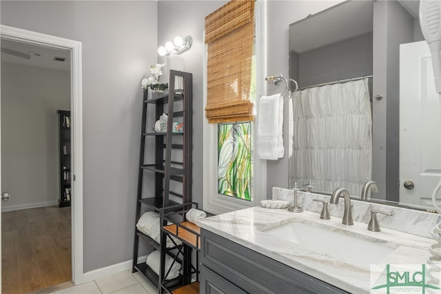 bathroom with walk in shower, vanity, and hardwood / wood-style floors