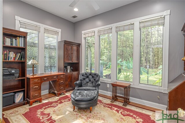 office space featuring light wood-type flooring, ceiling fan, and plenty of natural light