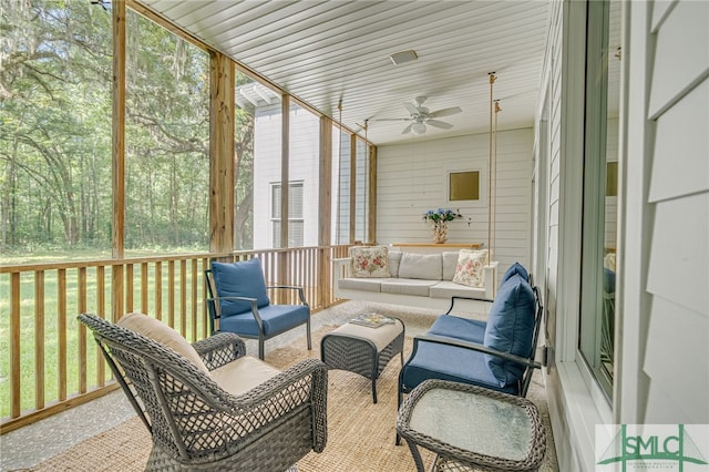 sunroom / solarium with plenty of natural light and ceiling fan