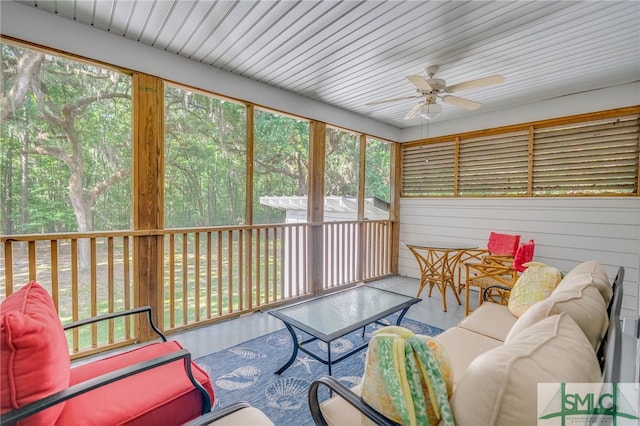 sunroom featuring ceiling fan