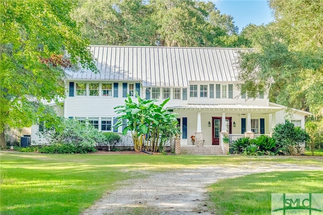 view of front of home featuring cooling unit, a front yard, and a porch