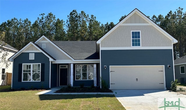 craftsman house featuring a front yard, central AC, and a garage