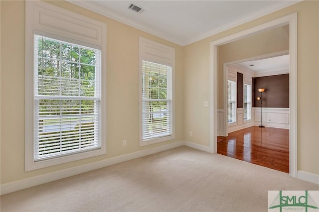 unfurnished room featuring carpet floors, plenty of natural light, and ornamental molding