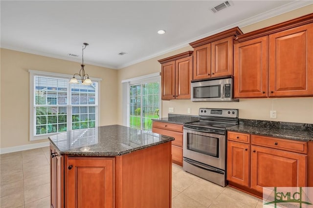 kitchen with appliances with stainless steel finishes, a center island, plenty of natural light, and a notable chandelier