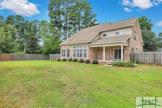 back of house with a yard