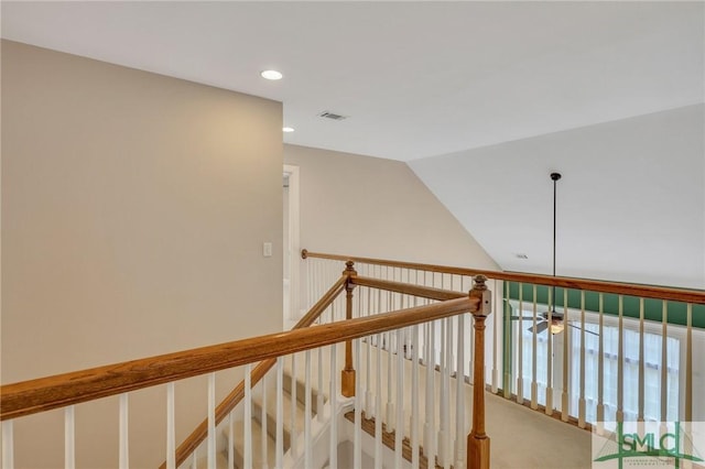 stairway with carpet flooring and vaulted ceiling