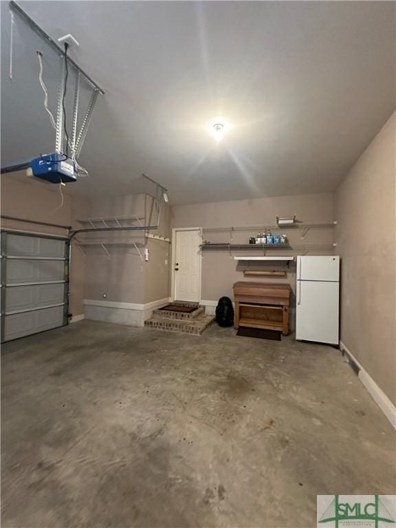 garage with white fridge and a garage door opener