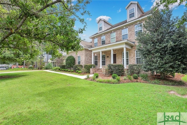 colonial-style house featuring a front yard