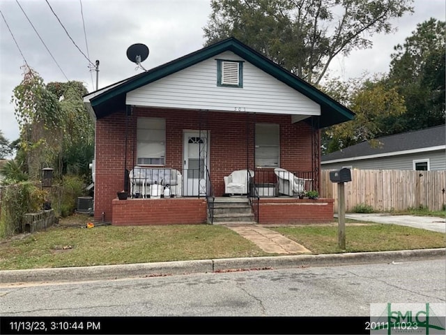 503 Gould St, Savannah, GA 31405 - view of front of home featuring brick siding, a porch, and central air condition unit