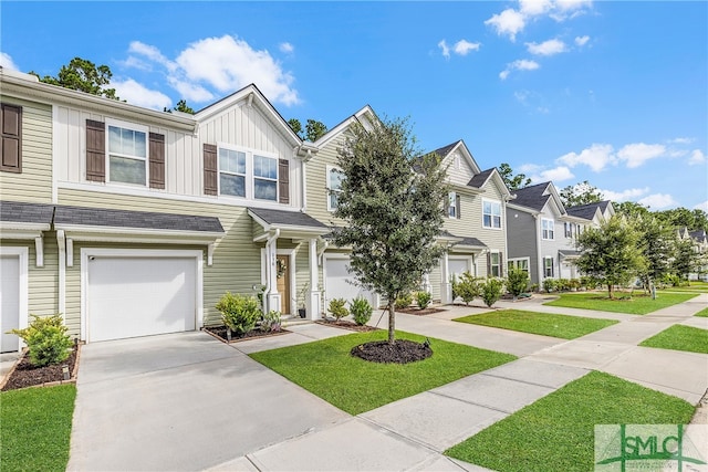 townhome / multi-family property with a front lawn, a residential view, board and batten siding, concrete driveway, and an attached garage