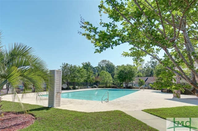 view of swimming pool with a yard and a patio