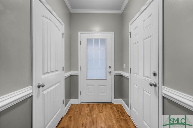 doorway to outside featuring light hardwood / wood-style flooring and ornamental molding