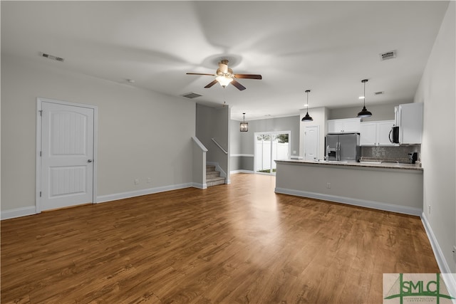 unfurnished living room with ceiling fan and light hardwood / wood-style flooring