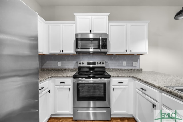 kitchen featuring decorative backsplash, stainless steel appliances, white cabinetry, and light stone counters