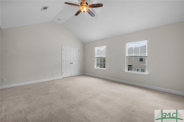 unfurnished room featuring ceiling fan, lofted ceiling, and light carpet