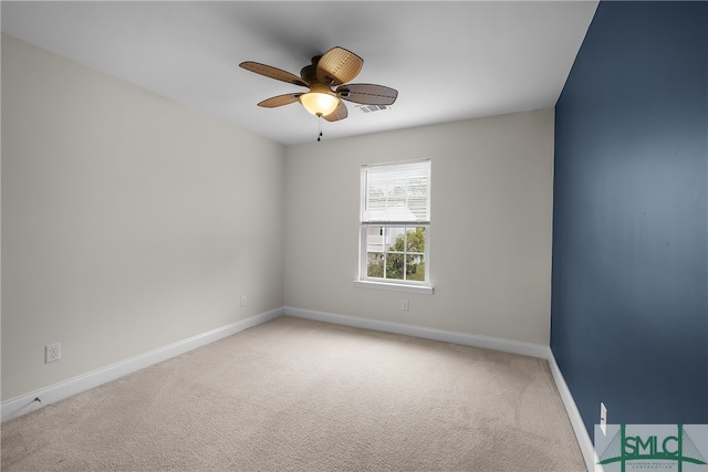 spare room with carpet and ceiling fan