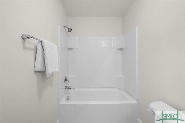 bathroom with toilet and washtub / shower combination