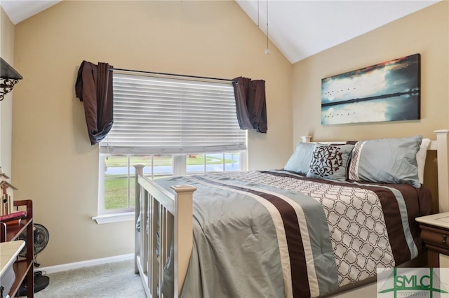 carpeted bedroom with lofted ceiling