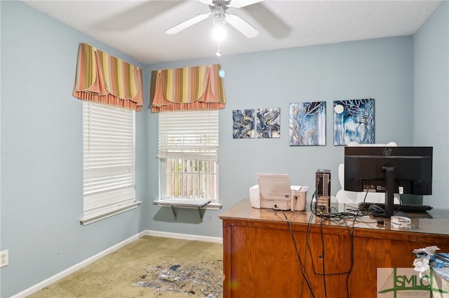 carpeted office space with ceiling fan