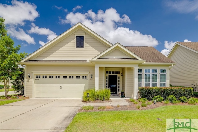 view of front facade with a garage and a front lawn