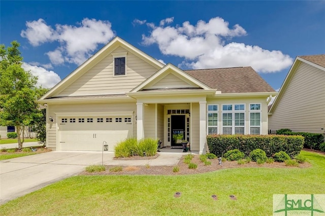 view of front of house featuring a garage, driveway, a front lawn, and a shingled roof