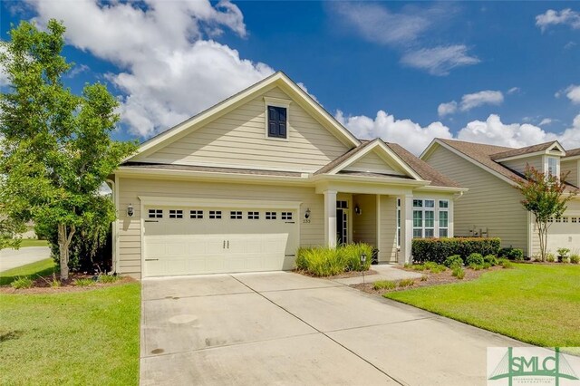 view of front of house with a garage and a front yard