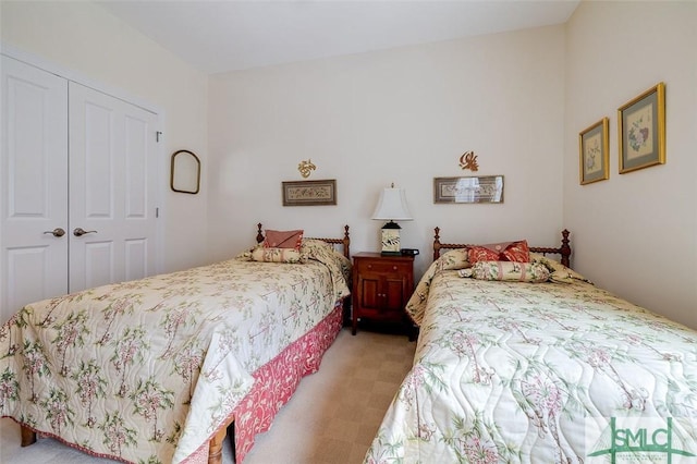 bedroom with light carpet and a closet