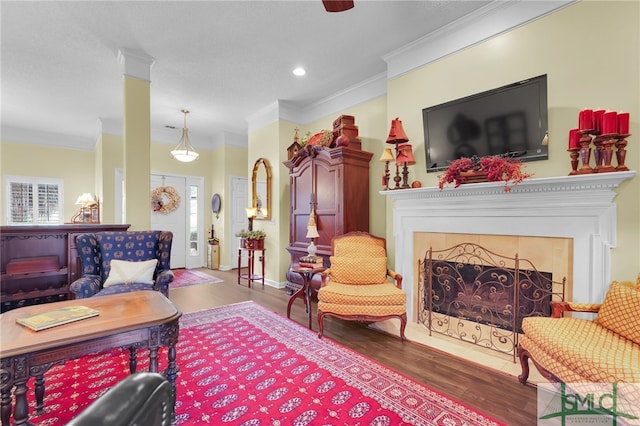 living room with dark hardwood / wood-style floors and crown molding