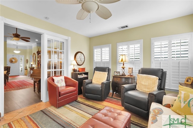 living room with light wood-type flooring and ceiling fan