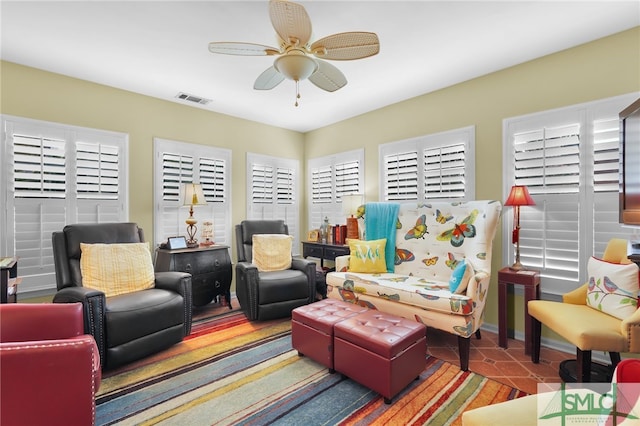 tiled living room with ceiling fan