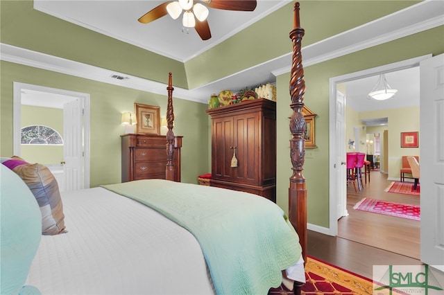 bedroom featuring ceiling fan, dark hardwood / wood-style floors, and ornamental molding